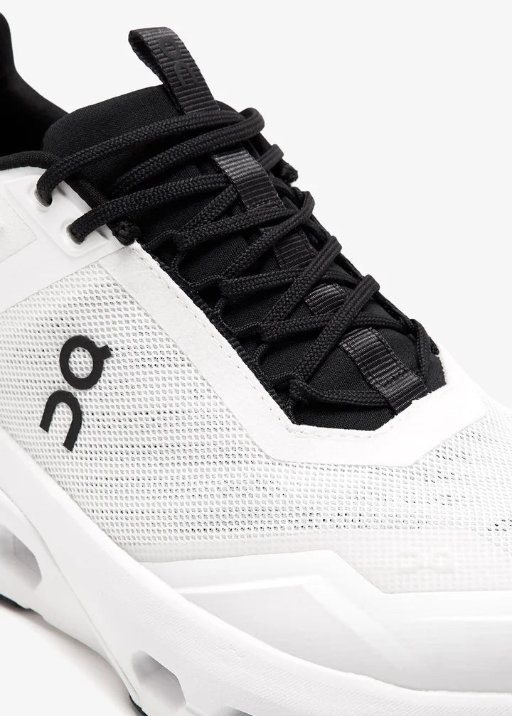 3we30410462-whtblk_5 | UAE SPORT STORE Close-up of a white mesh athletic sneaker with black laces and sole, featuring the On logo on the side.