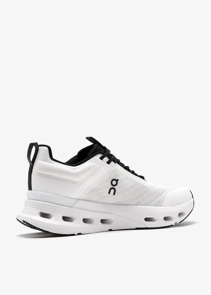 3we30410462-whtblk_6 | UAE SPORT STORE White running shoe with black laces and a perforated side panel, On brand logo visible on the midsection.
