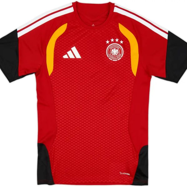 Red soccer jersey with white Adidas logo and DFB crest, black sleeves, and yellow shoulder accents.