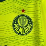 Close-up of neon yellow high-visibility fabric with a red star and a circular emblem nearby.