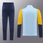 Navy pants on the left and a light blue top with yellow sleeves on the right, against a gray gradient background.