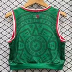 43d528f3-45d0-4ac1-988b-2de0dce5897a | UAE SPORT STORE Back view of a green sleeveless jersey with red and white trim, hanging on a wooden hanger, featuring a circular geometric pattern.