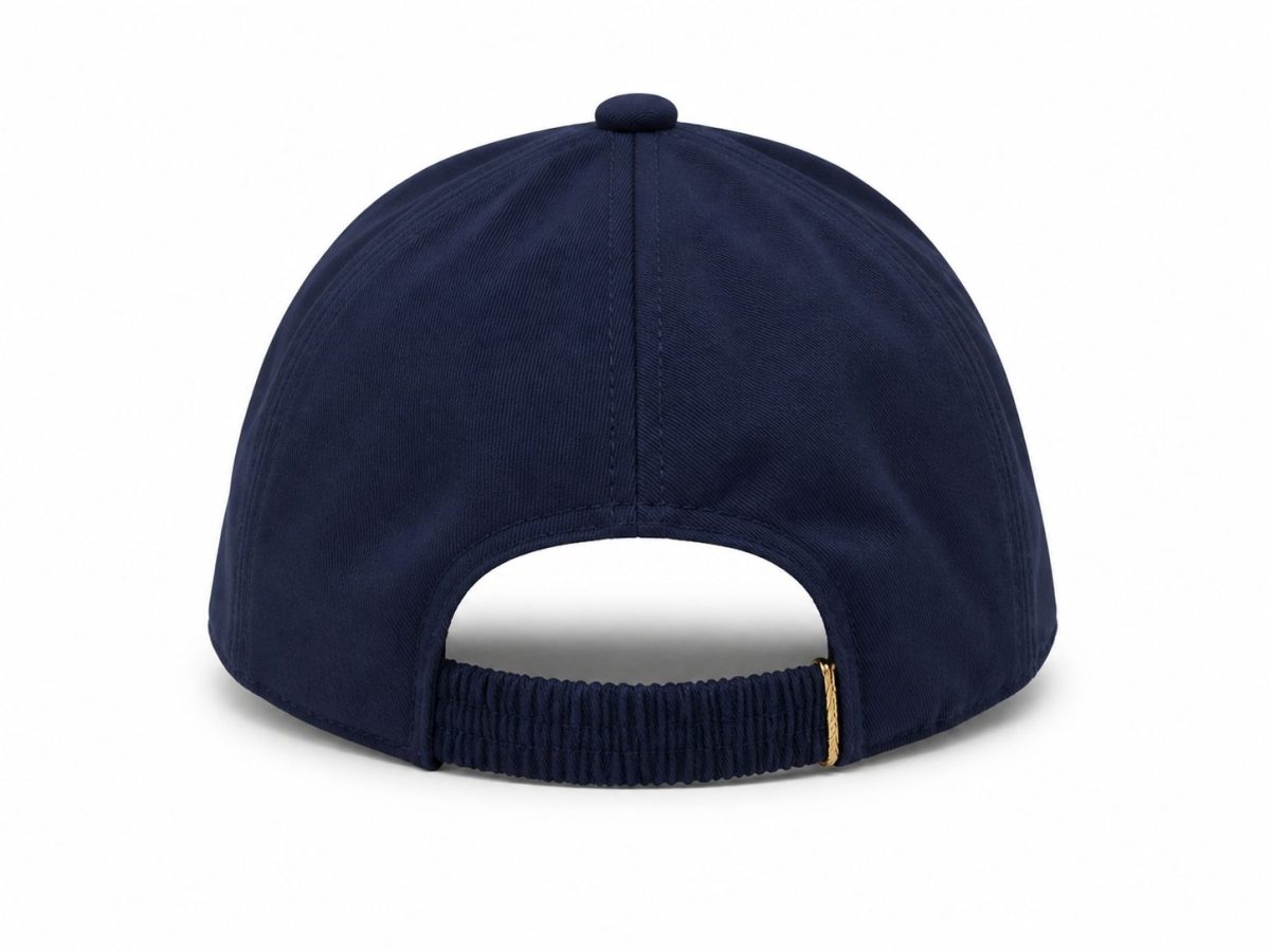 Back view of a navy blue baseball cap with an adjustable strap and small gold buckle showing at the rear area.