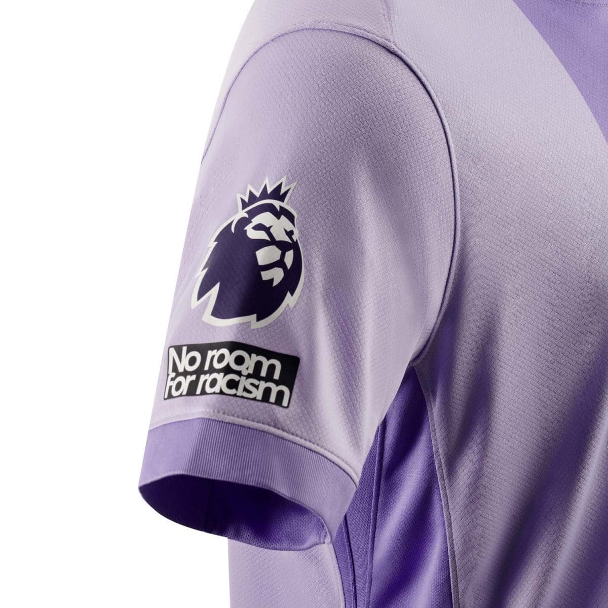 Close-up of a purple football jersey sleeve showing the Premier League logo and the 'No room for racism' badge.