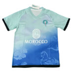 Morocco national soccer jersey with blue gradient, crest on chest and MOROCCO sponsor logo on front.