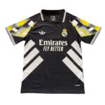 Black Real Madrid soccer jersey with white geometric accents and Emirates Fly Better sponsor logo