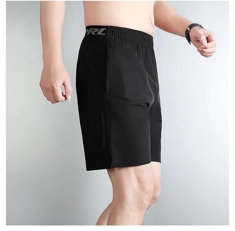 45e0cb88_1 | UAE SPORT STORE Side view of a man wearing black athletic shorts with an elastic waistband and a pocket visible on the side.