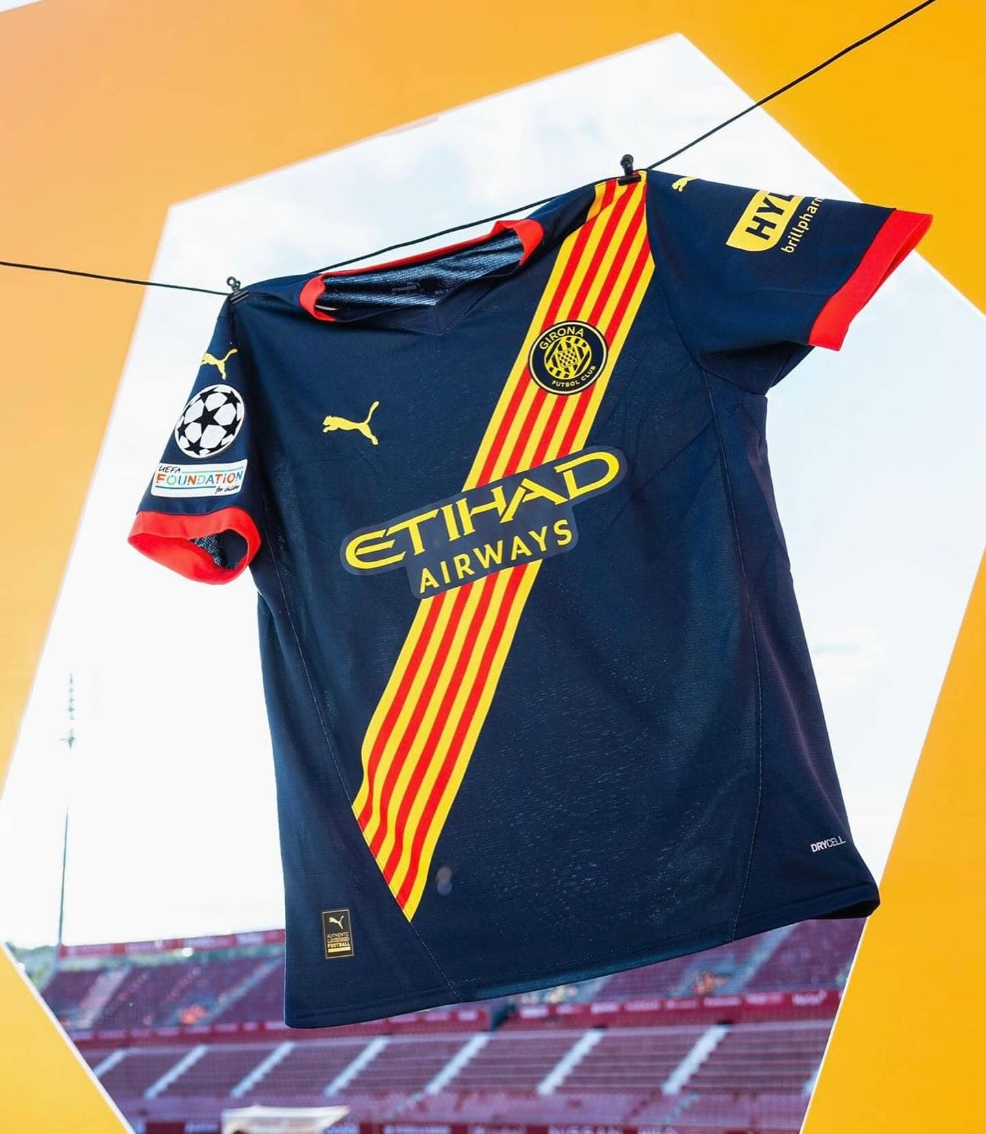 461616982_17940808724903197_2009866354023351200_n | UAE SPORT STORE Barcelona football jersey hanging on a clothesline with the club crest and yellow-red diagonal sash, stadium in background