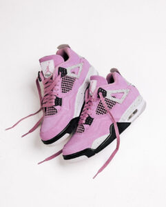 Pink Air Jordan sneakers with white and black accents on a white background.