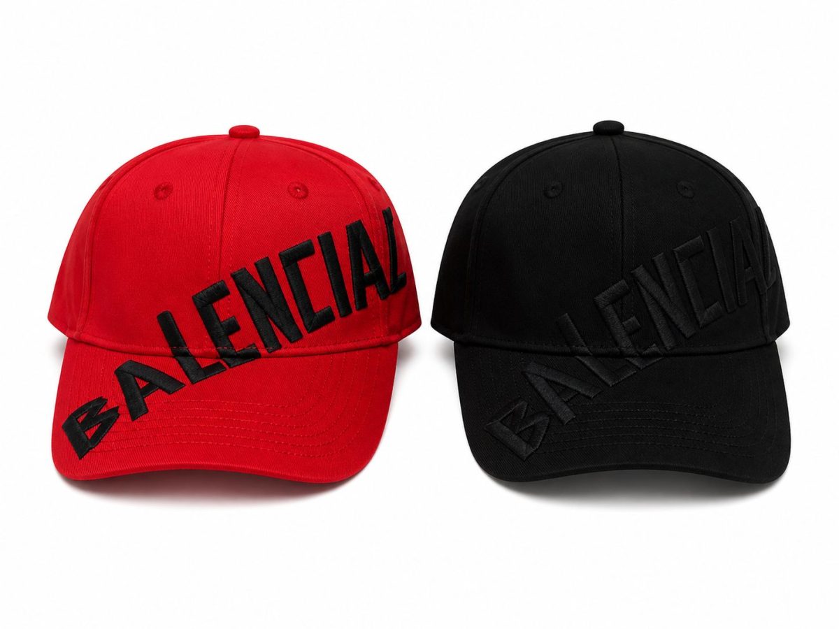 Red and black Balenciaga baseball caps with diagonal black lettering across the crown, shown side by side.