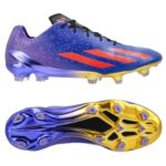 Purple-blue soccer cleat with orange chevron stripes and a yellow sole, shown from side with studded outsole.