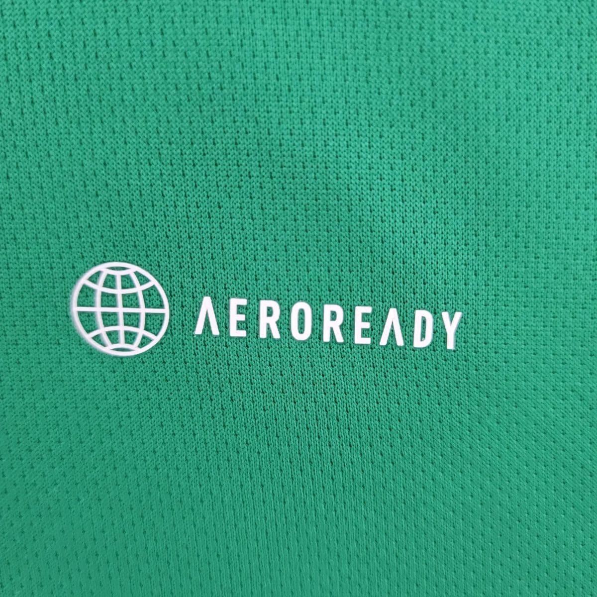 Green fabric texture with a white globe icon and the word 'AEROREADY' visible.