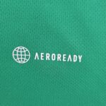 Green fabric texture with a white globe icon and the word 'AEROREADY' visible.