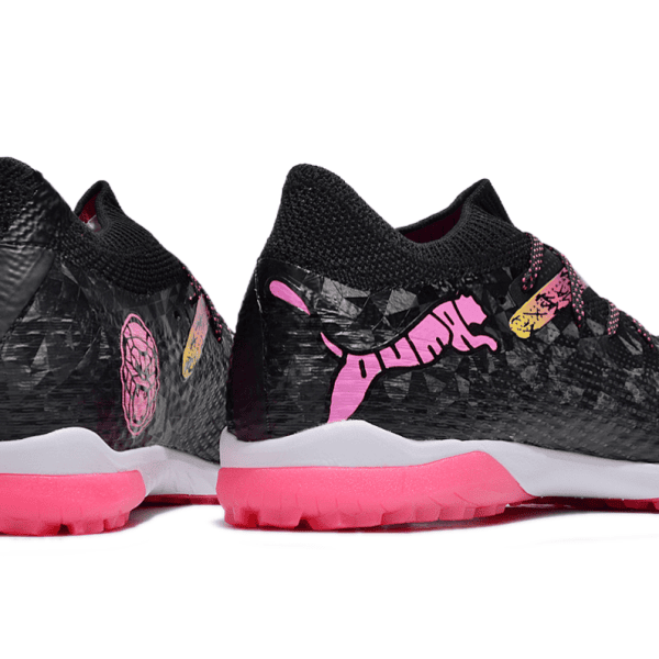Pair of black athletic sneakers with bright pink soles and pink logo graphics on the sides.