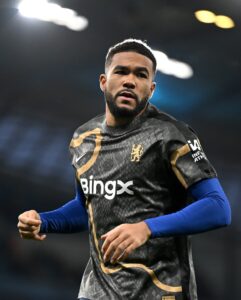 474931309_18492982948021107_4359508959673634716_n | UAE SPORT STORE Soccer player in a dark patterned jersey running on the field, blue undershirt visible at the arms, focused expression.