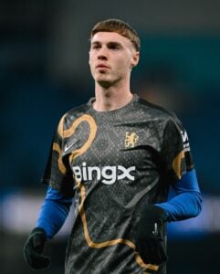474960219_18492982966021107_3992036470322195834_n | UAE SPORT STORE Portrait of a male soccer goalkeeper in a black patterned jersey with gold trim and BingX logo on a field.