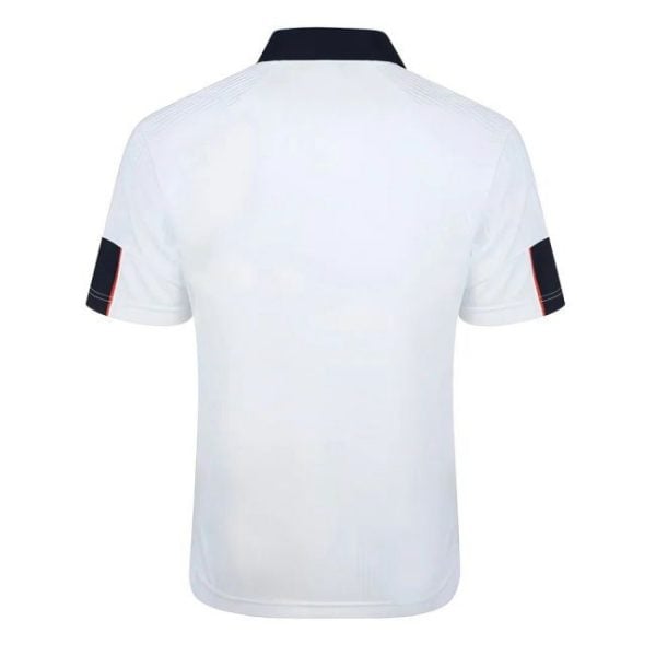 Back view of a white polo shirt with a navy collar and navy sleeve cuffs featuring red piping on the ends.
