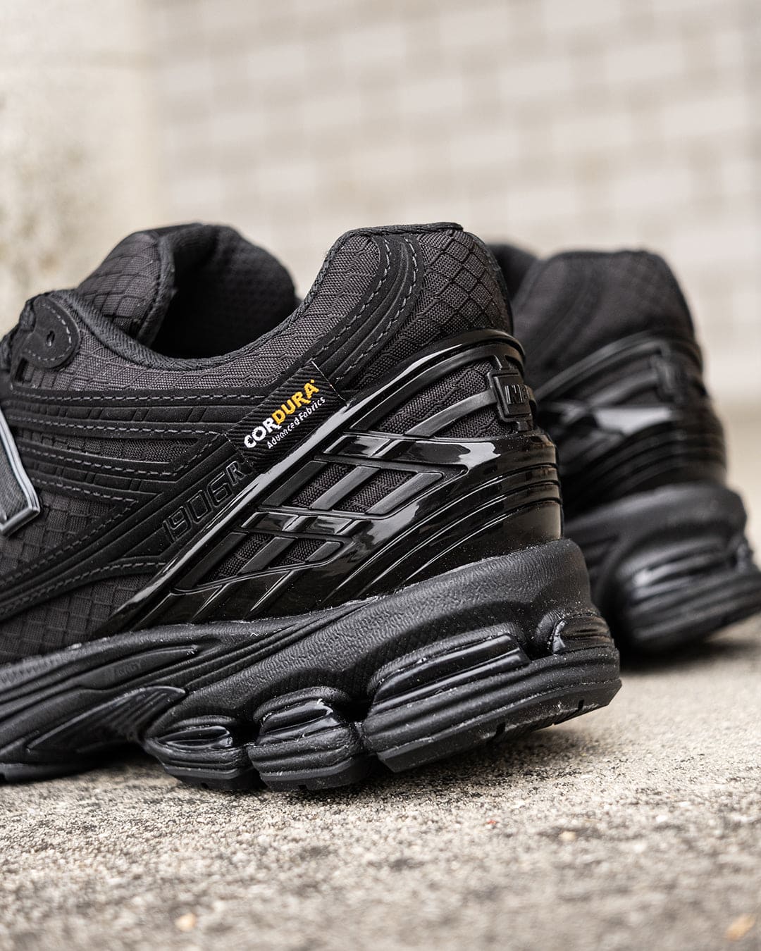 481779740_938860121751840_7141942974036878028_n | UAE SPORT STORE Close-up of black athletic sneakers with a chunky sole on pavement, highlighting the Cordura fabric tag.