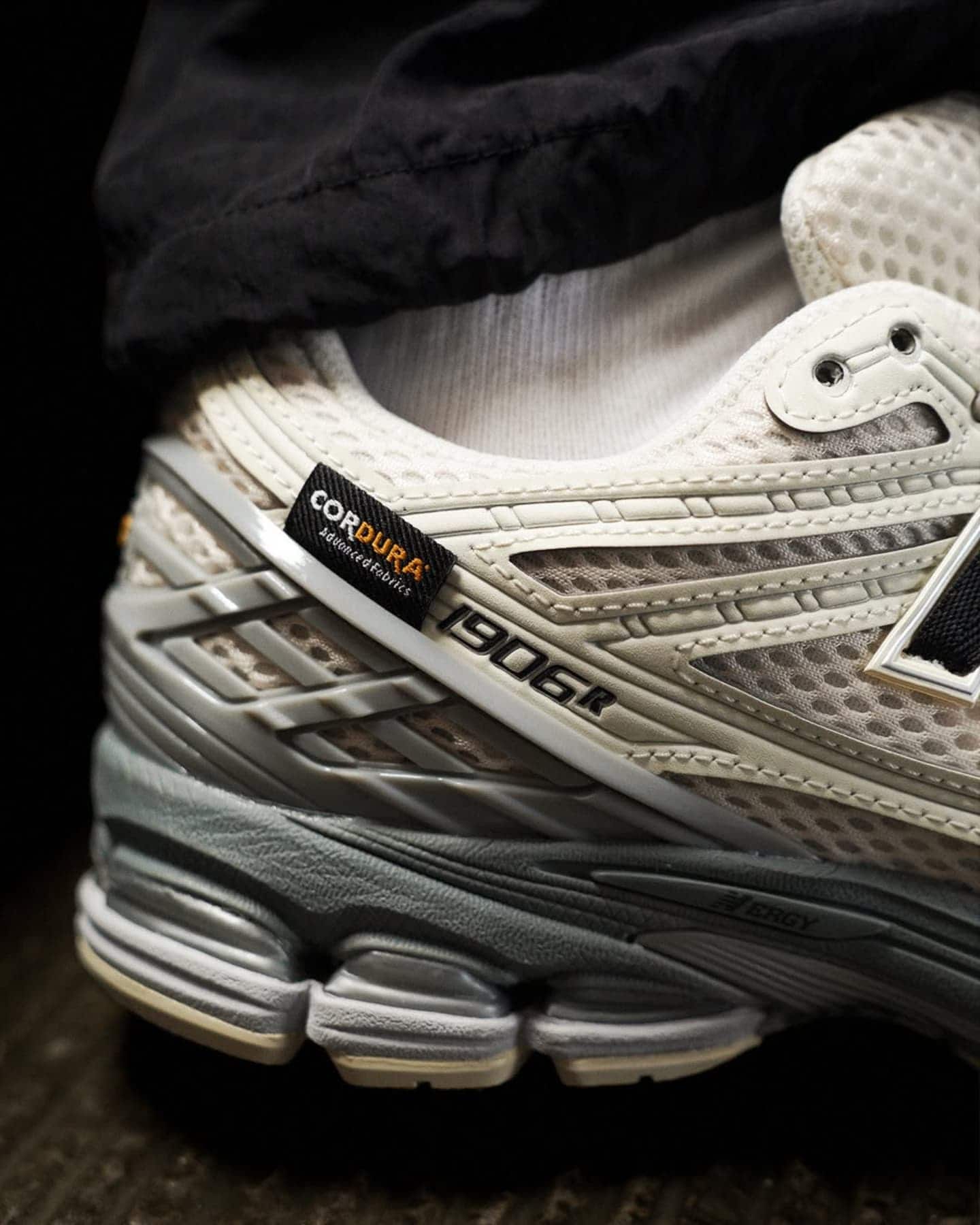 486841730_1208432037562081_354636231591888337_n | UAE SPORT STORE Close-up of a light beige athletic shoe with mesh panels, showing a black Cordura tag and