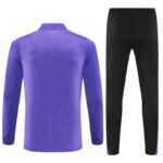 Purple long-sleeve athletic top with a textured pattern paired with black textured athletic pants.