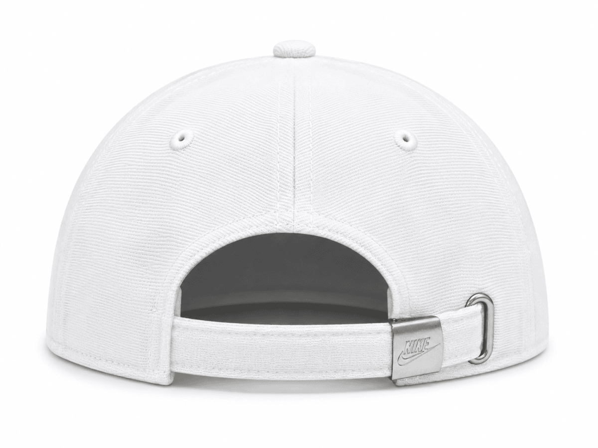 White Nike cap as seen from the back, showing an adjustable strap with a metal buckle and D-ring closure.