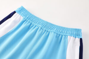 4a0e7866 | UAE SPORT STORE Light blue athletic shorts with white side panels and a navy stripe, featuring an elastic waistband.