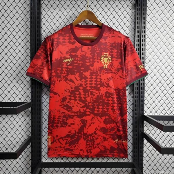Red Portugal national team jersey hanging on a wooden hanger against a metal grid backdrop, showing crest on the chest area.