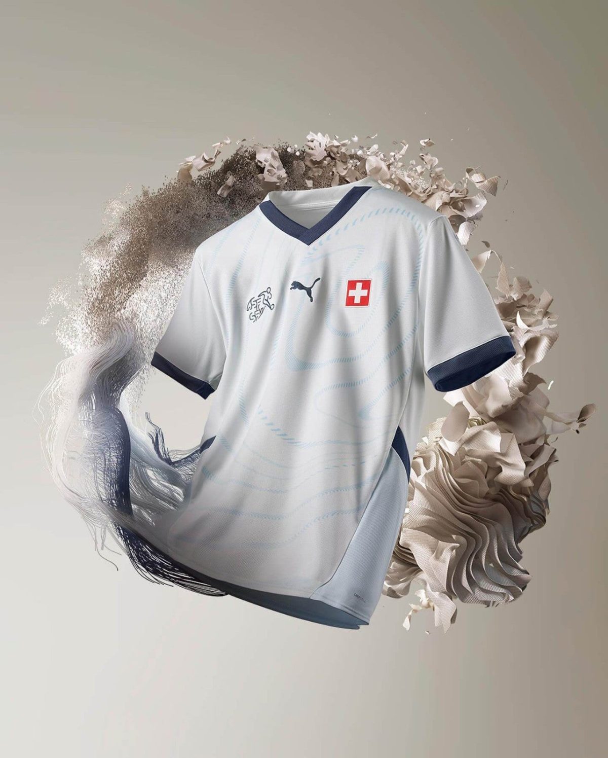 White Switzerland team jersey with blue V-neck trim and Puma logo, featuring a red Swiss flag crest on the chest, against an abstract background.