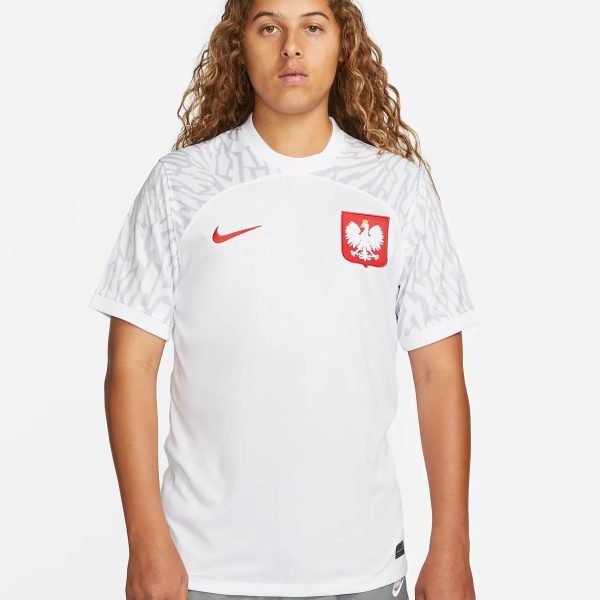 Person wearing a white Poland national team soccer jersey with a red eagle crest and red Nike swoosh, facing the camera.