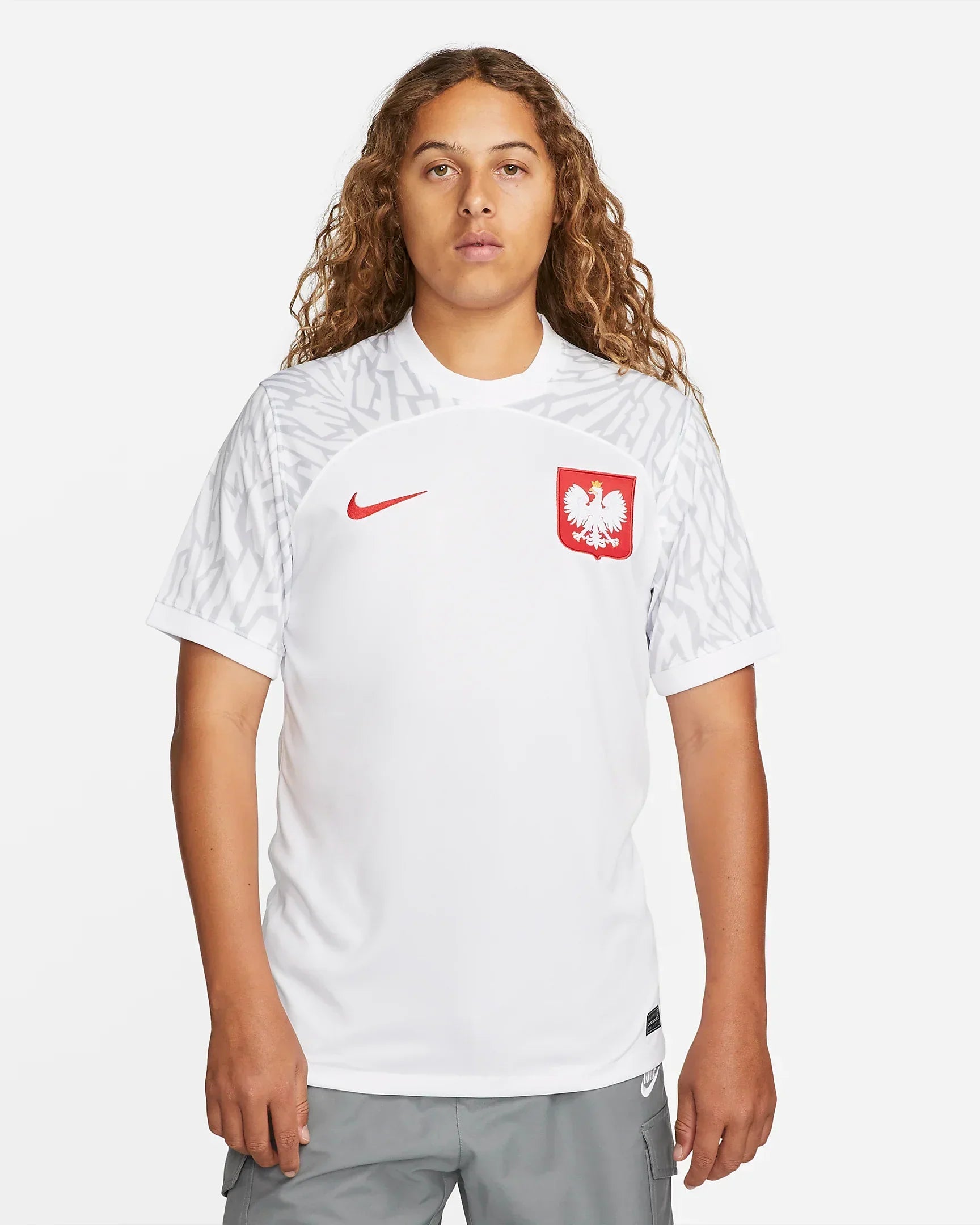 4b4d0623-3b10-4963-86ba-76c8c4c949c8_c28053fe-157b-4a80-bb62-565ac17db496 | UAE SPORT STORE Person wearing a white Poland national team soccer jersey with a red eagle crest and red Nike swoosh, facing the camera.