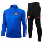 Manchester United blue training jacket with white stripes and matching black track pants, both featuring the club crest and Adidas logos