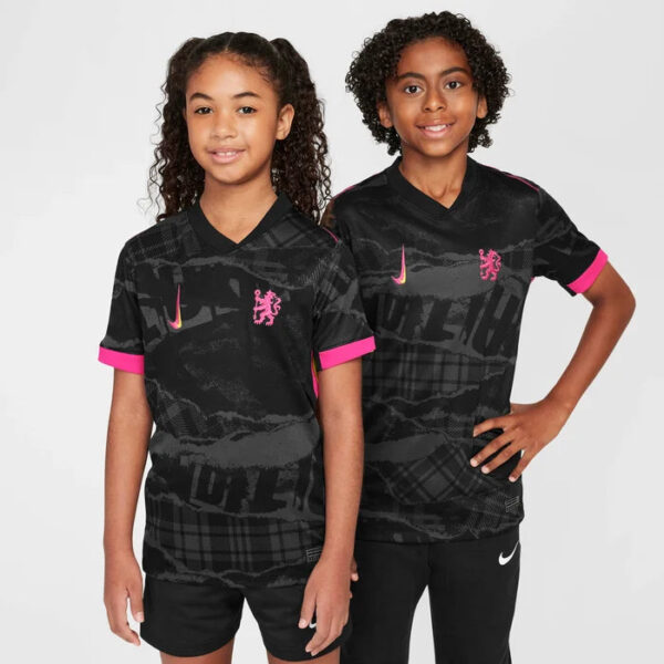 Two children stand side by side in black athletic jerseys with pink cuffs, featuring pink Nike swooshes and lion crests on the chest.