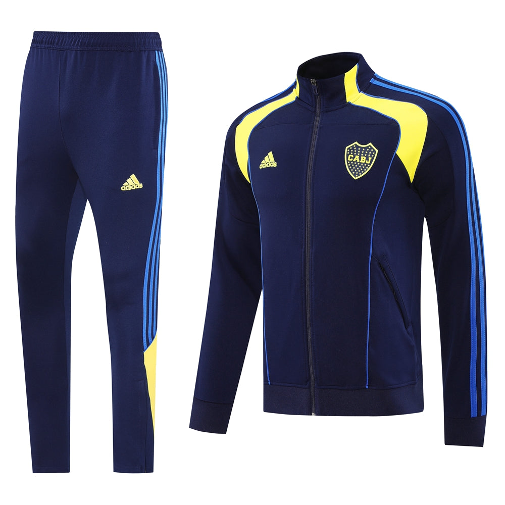 4e3eac36 | UAE SPORT STORE Navy Adidas track jacket and pants set with yellow accents and blue stripes, CABJ crest on the chest.