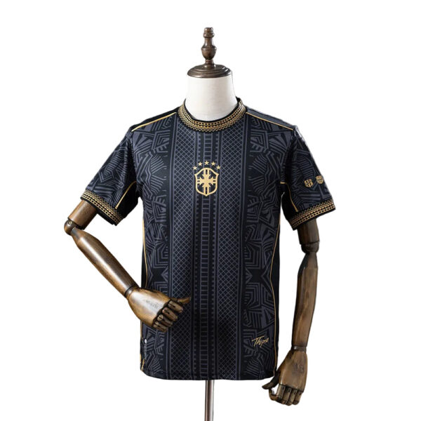 Black and gold patterned soccer jersey on a dress form, featuring crest and stars.