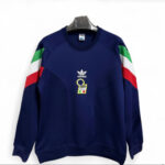 Navy blue Adidas sweatshirt with Italian flag color blocks on the sleeves, hanging on a metal hanger