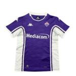 Purple soccer jersey with white side panels and Mediacom sponsor, Fiorentina club crest on the chest, short sleeves with white trim.