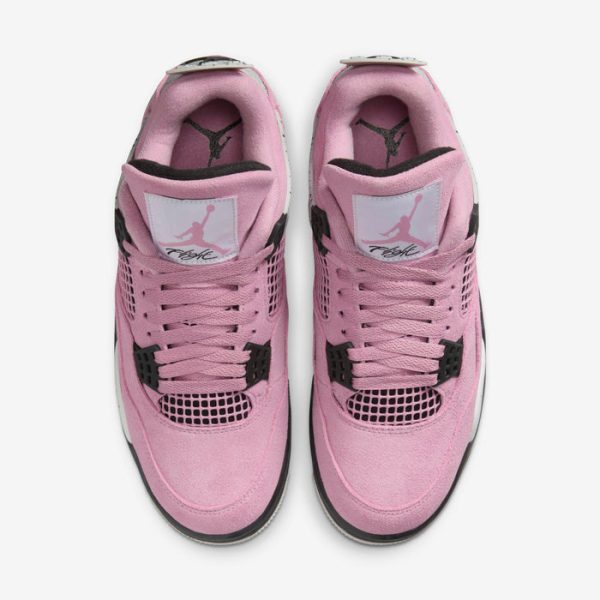 Top-down view of pink sneakers with black accents and white midsole, showing Jumpman logo on tongues (pair of shoes).