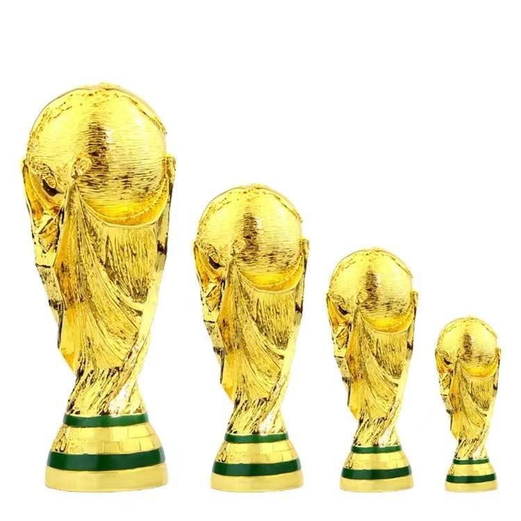 503edaa5-c0c6-465f-a322-caf553ba07ab_4146d913-095d-412f-8ec8-43702cbb5a4e Four gold trophies of varying heights lined up from largest on the left to smallest on the right against a white background.