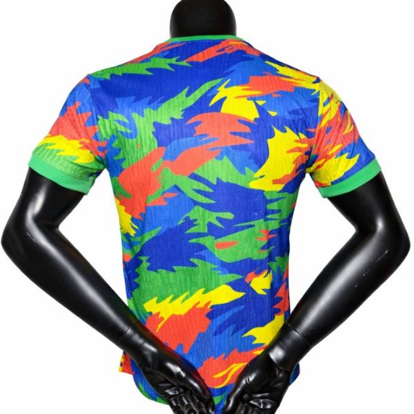 Back view of a blue shirt with bright green, yellow, orange, and red abstract pattern on a black mannequin