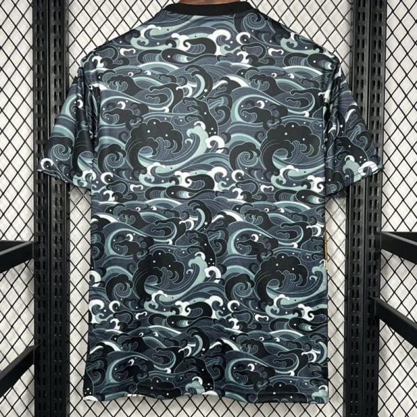 Back view of a short-sleeve shirt with a dark blue teal wave pattern covering the entire fabric.