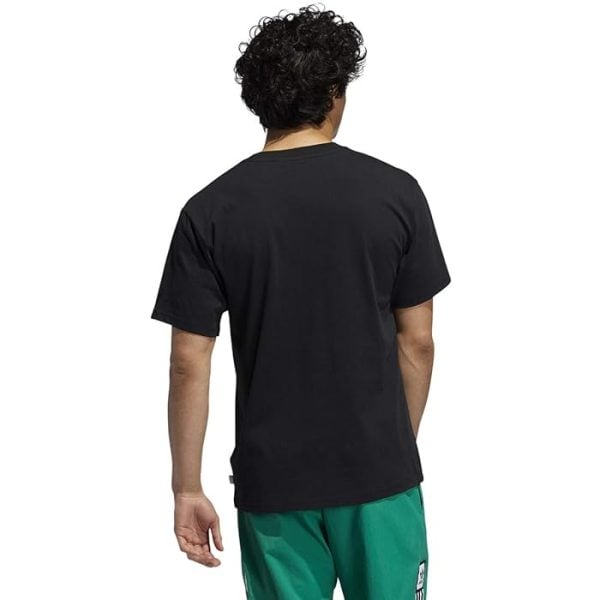Person viewed from behind wearing a plain black T-shirt and green shorts