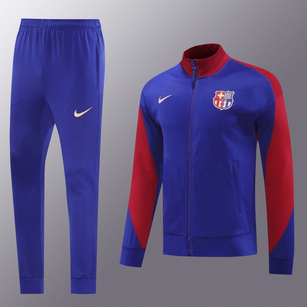Blue FC Barcelona training tracksuit with red sleeves, shown on a mannequin against a gray background.