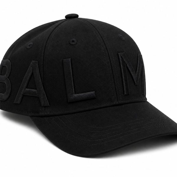 Black baseball cap with large, raised embroidered letters spelling BALM along the side of the crown.