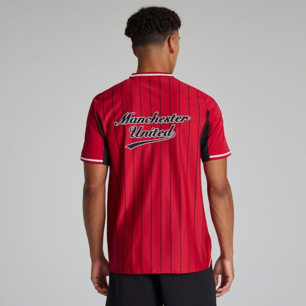 Back view of a man wearing a red Manchester United football jersey with thin black vertical stripes.