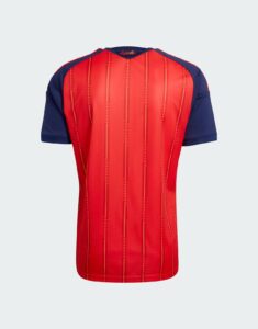 Back view of a red football jersey with blue sleeves and vertical orange pinstripes; small España text at the neck.
