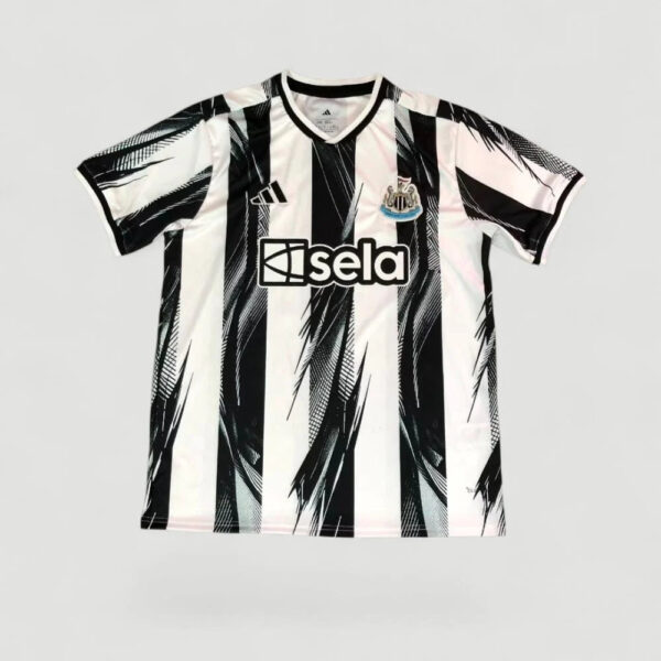 Newcastle United replica football jersey with black-and-white vertical stripes and sponsor 'isela' on the chest, crest visible.