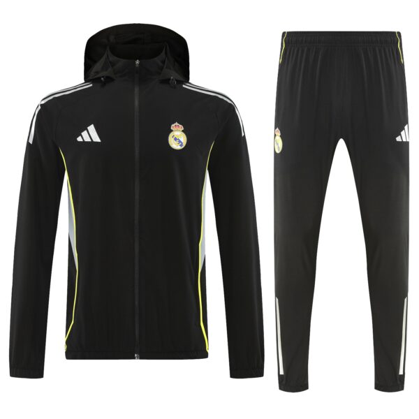 Black Real Madrid tracksuit: hooded zip-up jacket with white side stripes and crest, paired with matching black pants featuring neon-yellow piping.