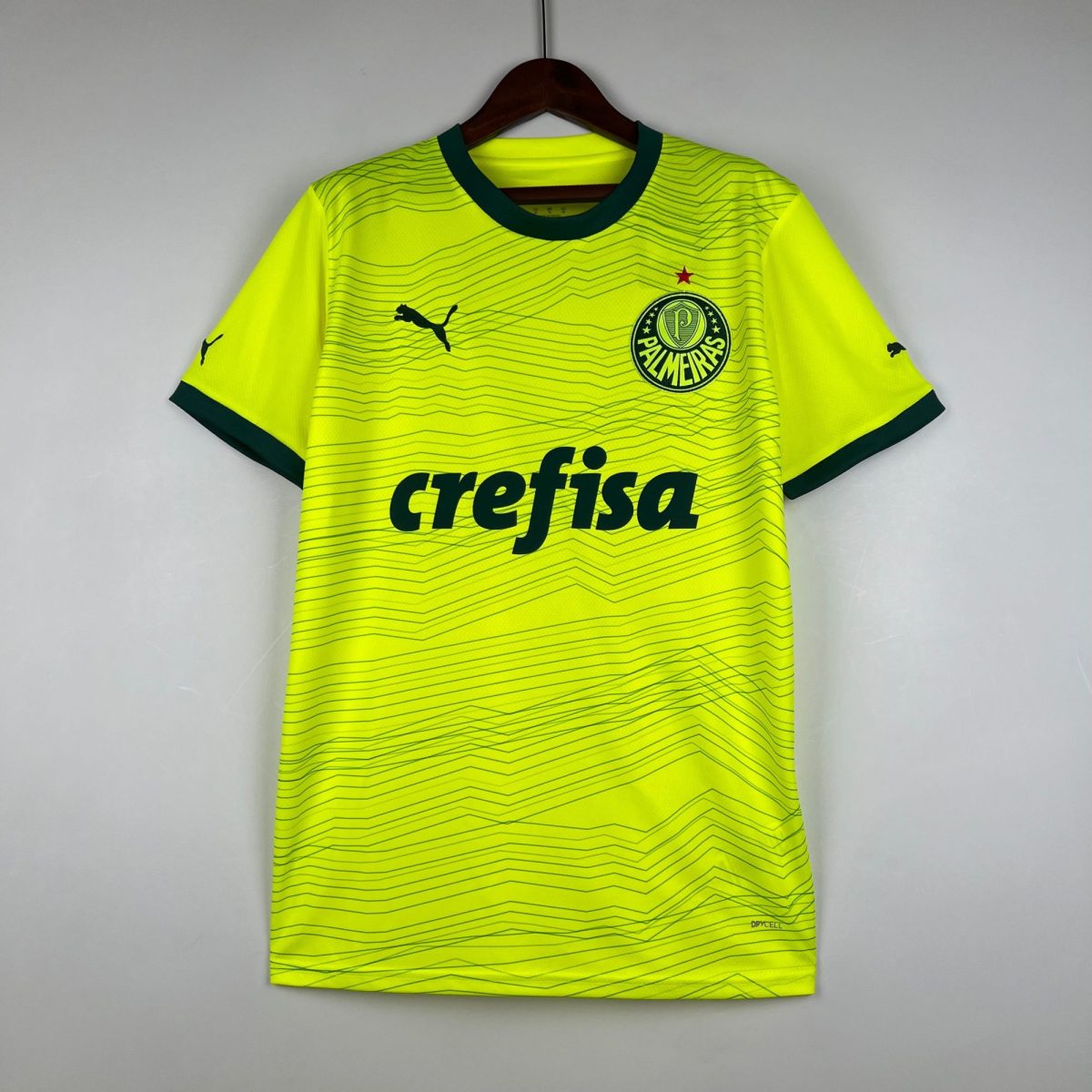 Bright neon yellow Palmeiras soccer jersey on a hanger, showing crest and sponsor text.