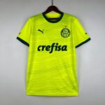 Bright neon yellow Palmeiras soccer jersey on a hanger, showing crest and sponsor text.