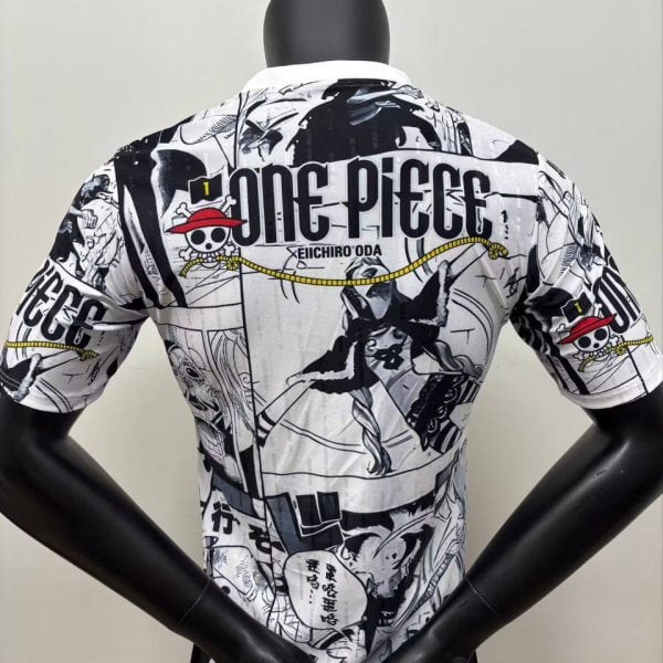 Back view of a white manga-themed shirt on a mannequin, covered in black-and-white One Piece panels with the text 'ONE PIECE' and 'EIICHIRO ODA'.